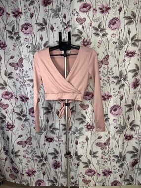 Trendy No Comment NY.LA pink wrap crop top with open back and tie detail. Stylis